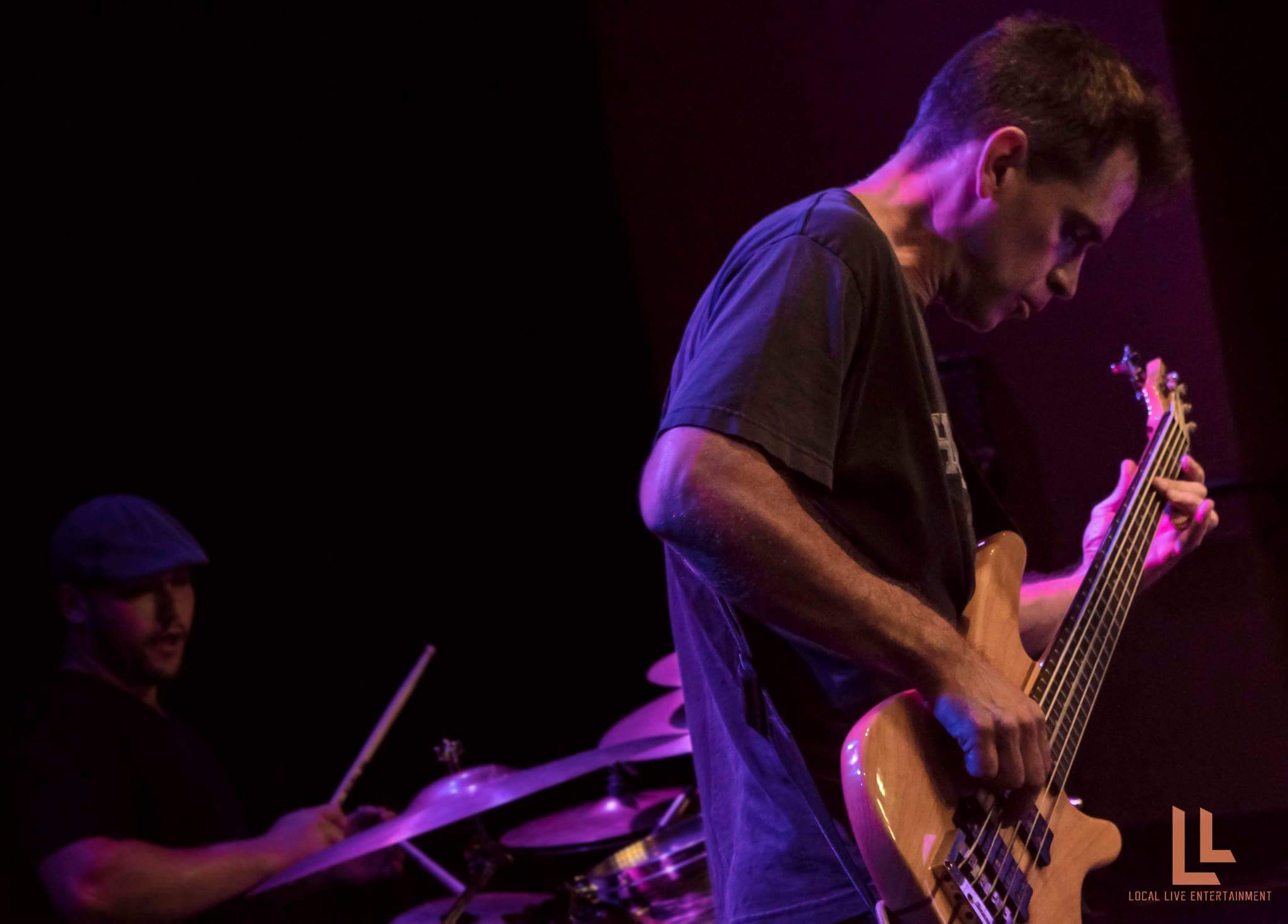 Matt Williams performing on bass guitar
